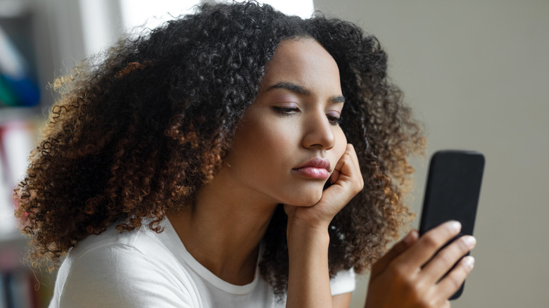 woman bored on phone