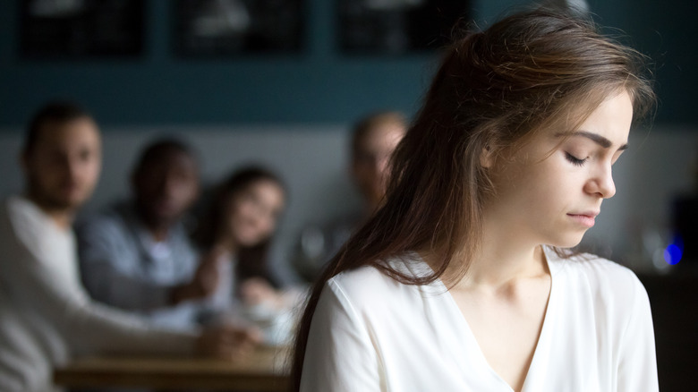 woman feeling alone around friends