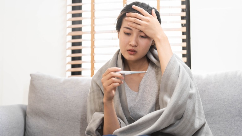 woman taking temperature