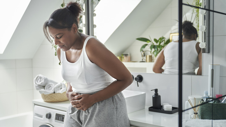 woman holding stomach