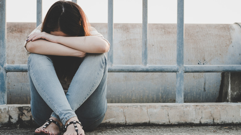 Woman sad head on knees