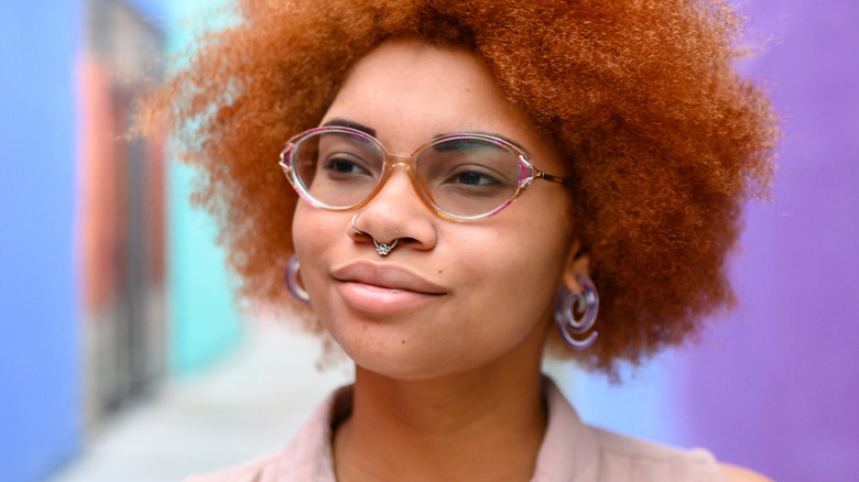 Woman with nose piercings and gauged ears