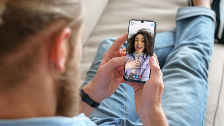 A man on a video call with a woman