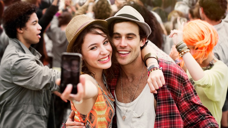 A couple taking a selfie at a concert