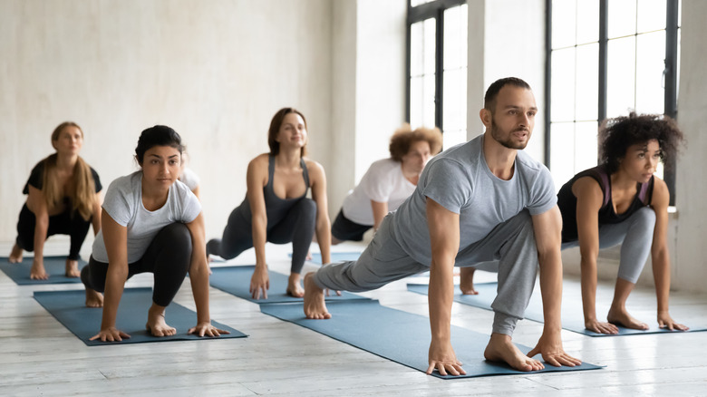 Group of people doing a low front lunge