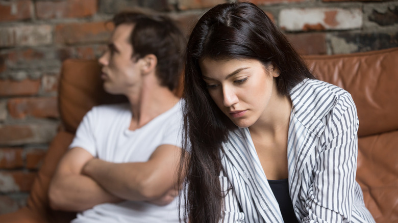 Upset couple on couch