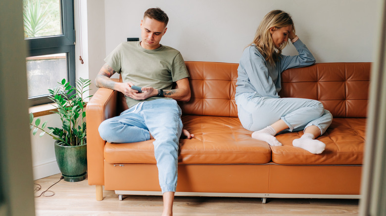 Distant couple on couch