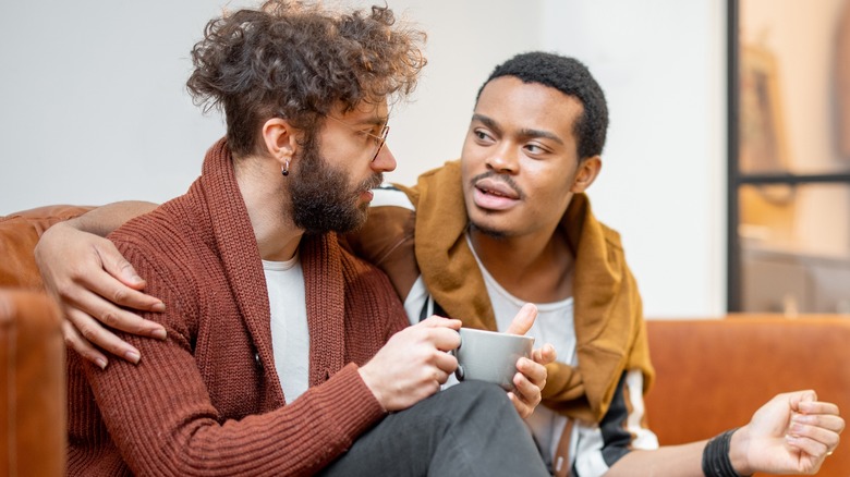 two men on couch talking