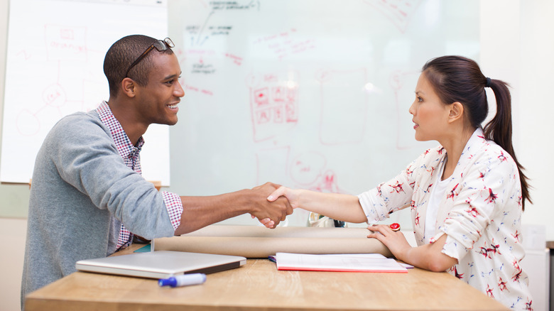 Man and woman shaking hands