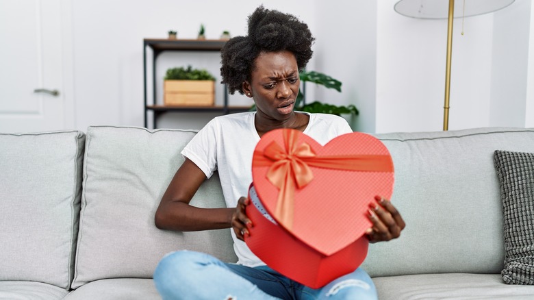 Woman with heart-shaped candy box 