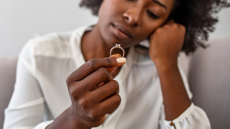 Woman taking her wedding ring off 