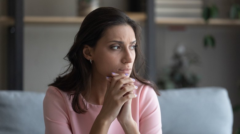 woman thinking on couch 