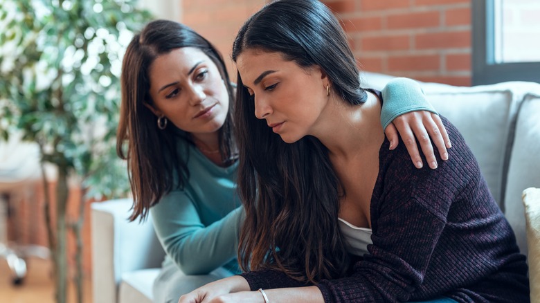 woman comforting another woman