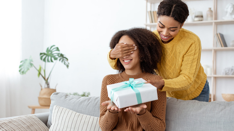 woman giving friend gift 
