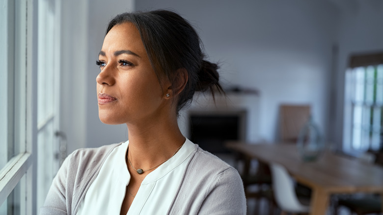 Woman looking out window