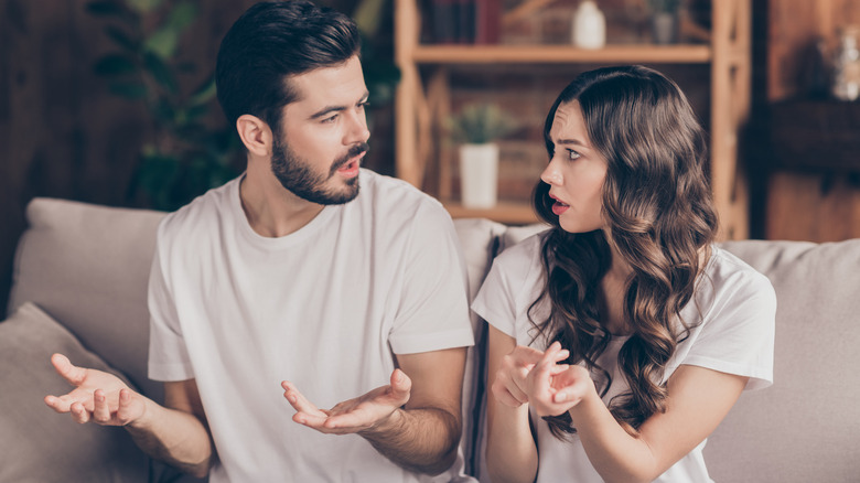 Couple arguing on couch