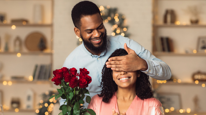 Man giving woman flowers