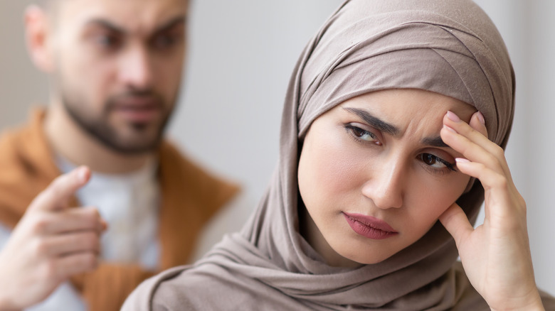 Angry man pointing at woman