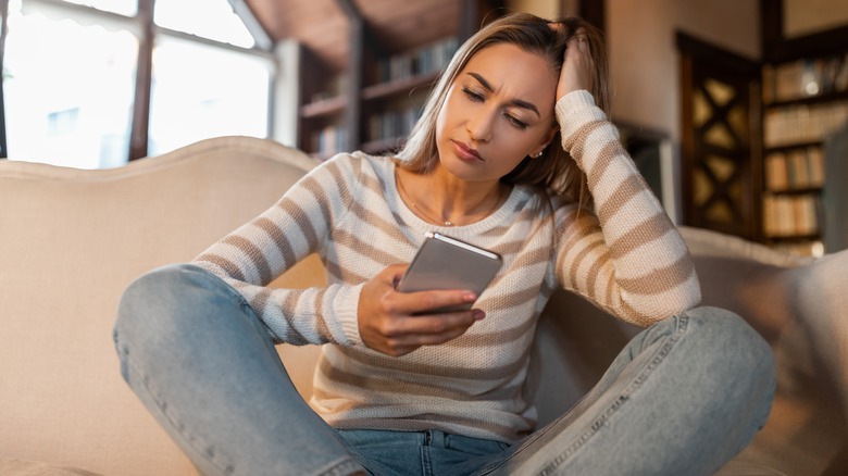 Woman sitting, using cell phone