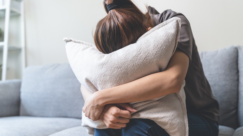 Woman with head in pillow