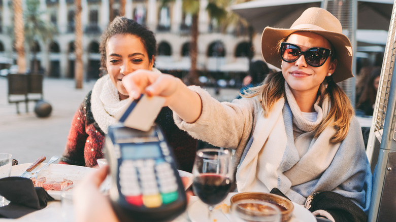 Woman picking up tab