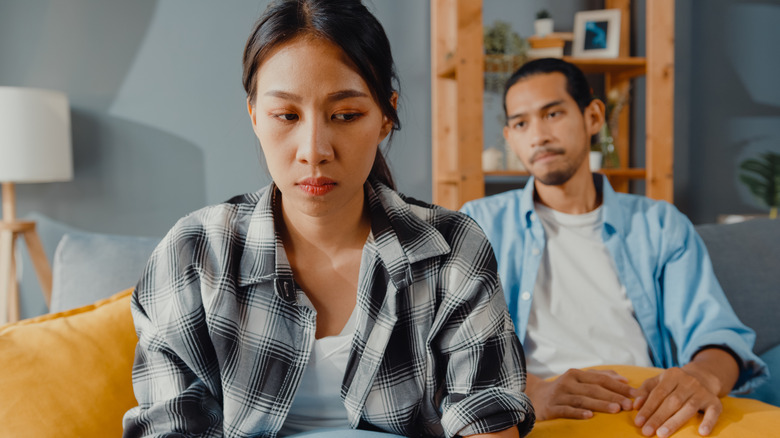 Unhappy couple on sofa