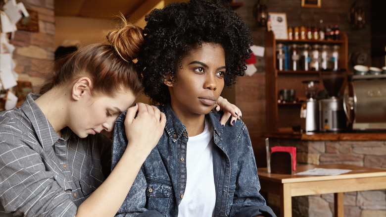 Woman hugging tense partner