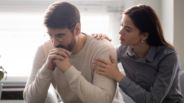 Woman trying to comfort man