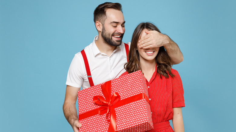 man giving gift to girl