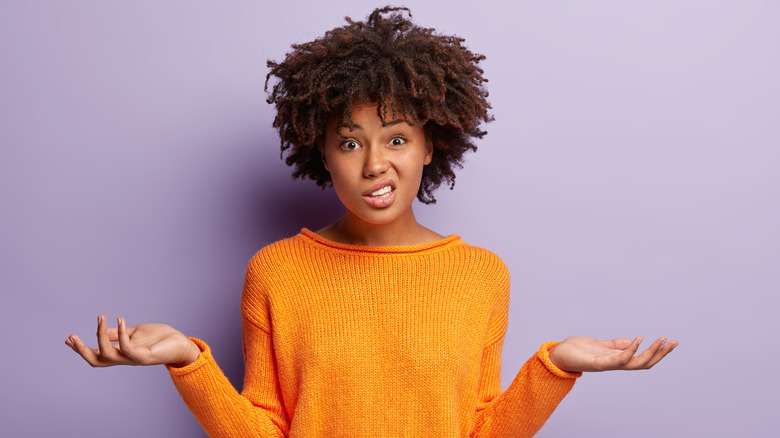 confused woman near purple background