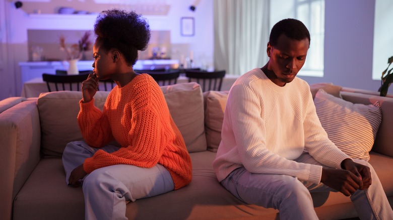 couple fighting on couch 