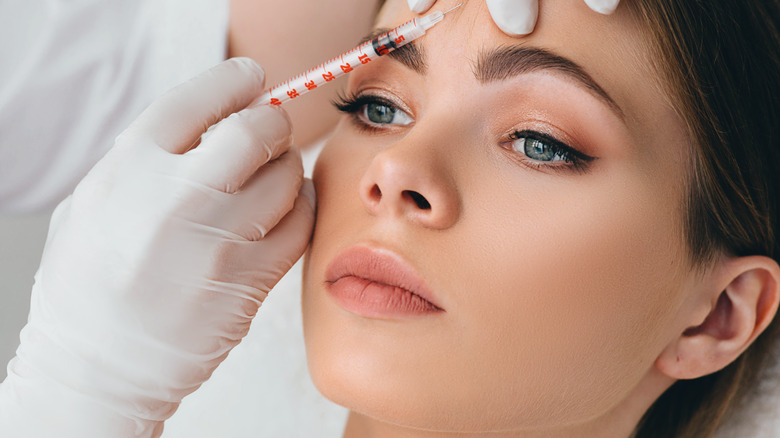 Model receiving Botox in forehead