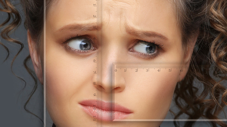 Model exaggerating facial asymmetry