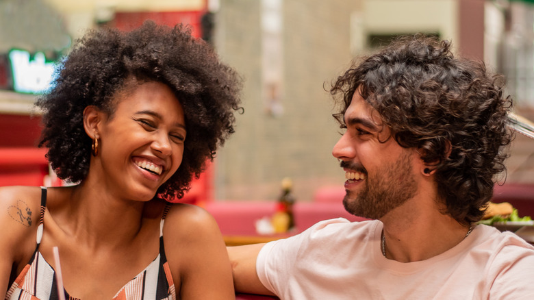 Man and woman smiling at each other