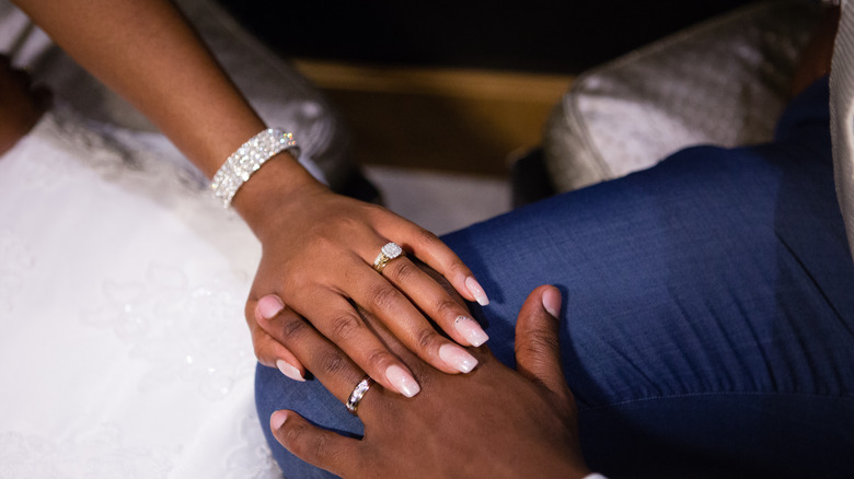 bride and groom touching hands