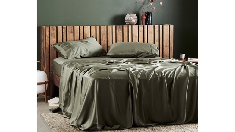 green silk sheets wood bed