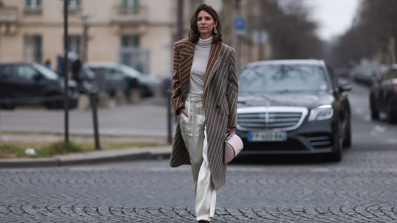 woman wearing cream silk pants 