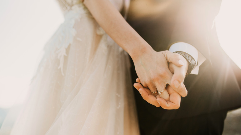 Close up of bride and groom's hands