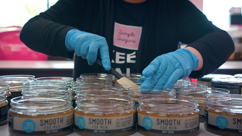 Worker filling Simple Sugars product jars