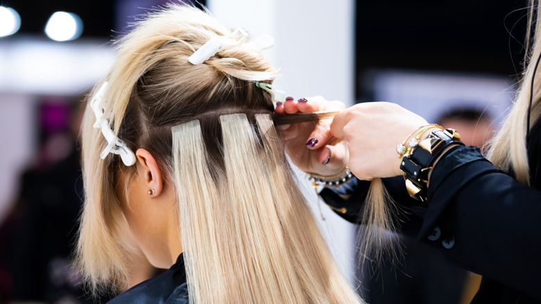 woman getting hair extensions