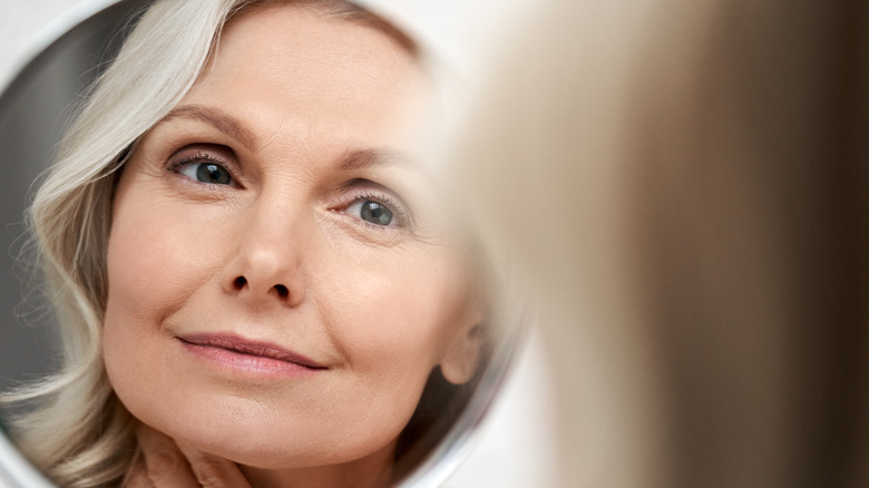 Mirror showing older woman's face