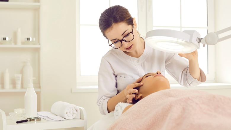 Woman is examined by dermatologist 