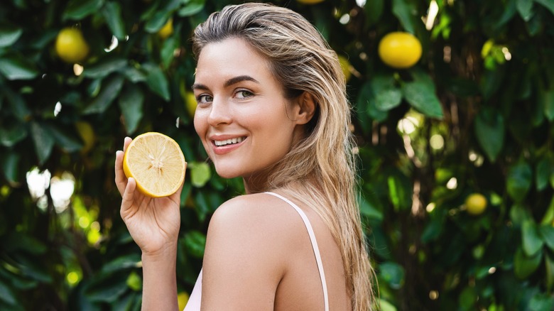 Woman holding grapefruit 