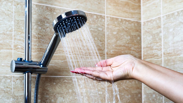 Hand testing shower water