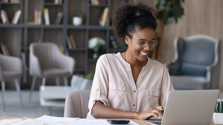 Woman at desk with calculator