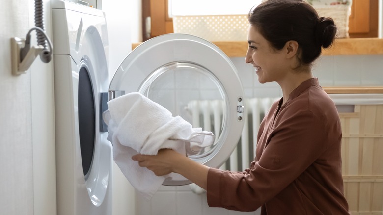 smiling woman doing laundry