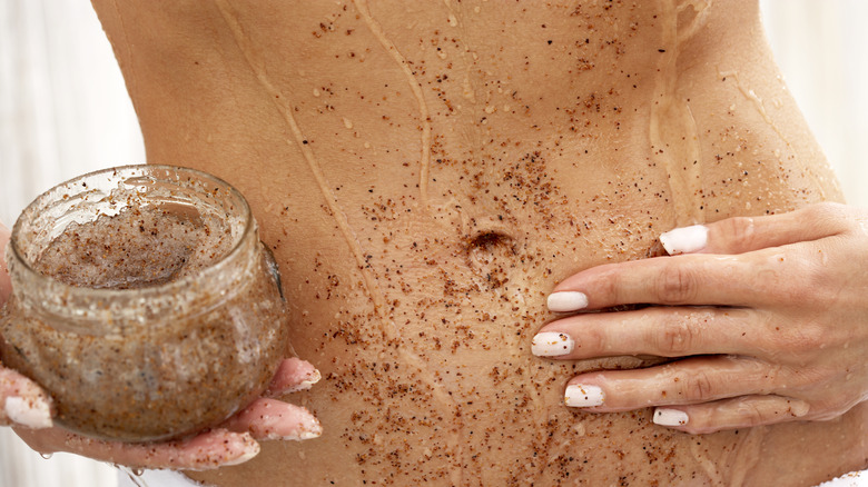 person using exfoliating scrub