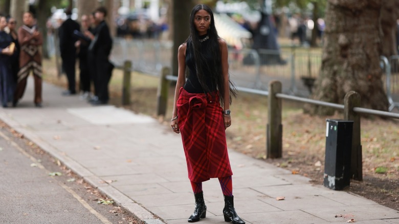 woman wearing plaid midi skirt