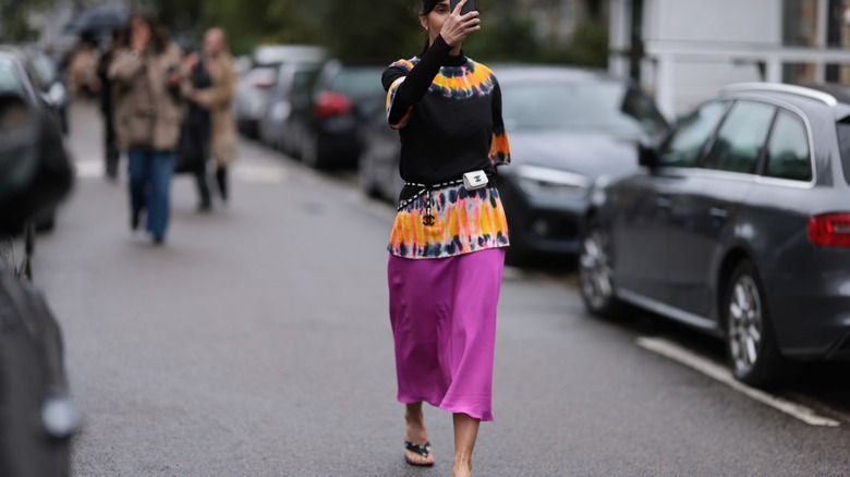 woman wearing satin midi skirt