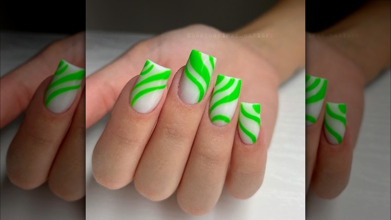 Woman wearing nails with green design